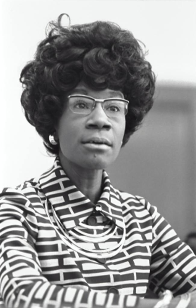 Image of a lady with glasses and pattern shirt